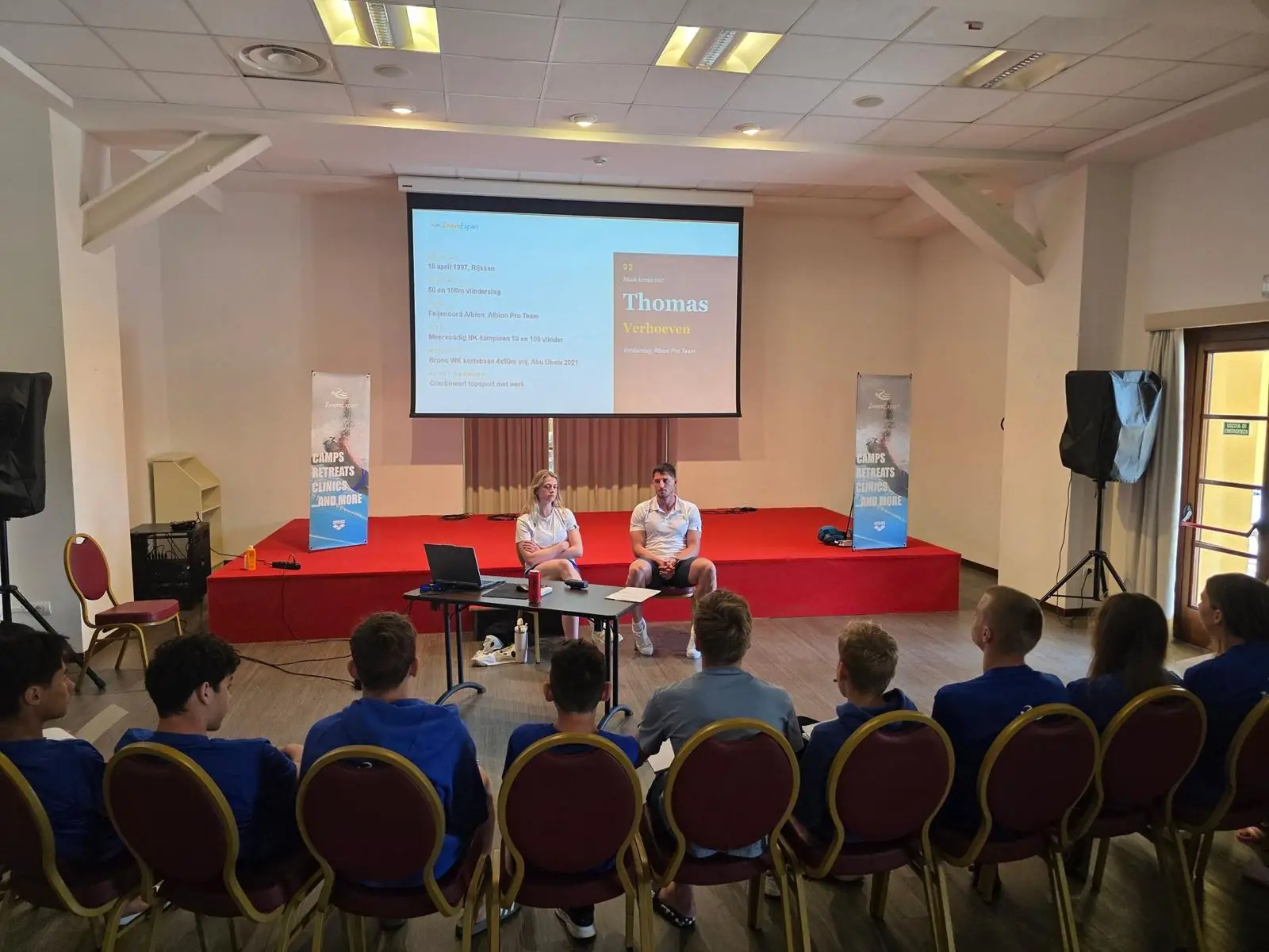 Swimmers in camp shirts at a race preparation seminar